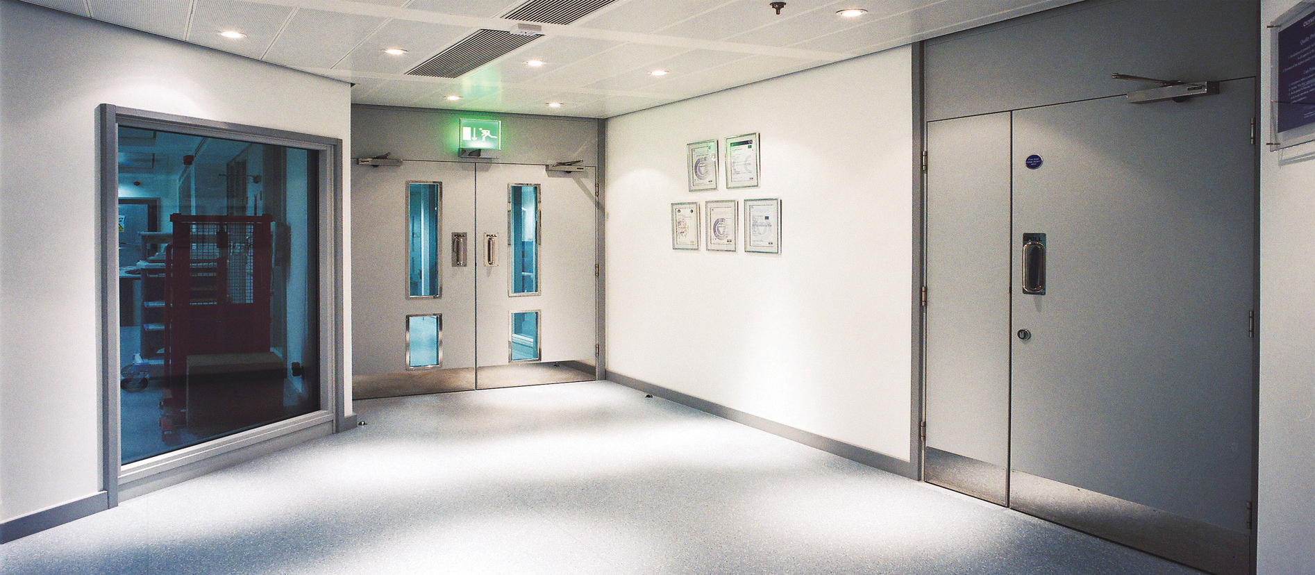 Metal doors in a specialist building corridor from the MKR website image collection